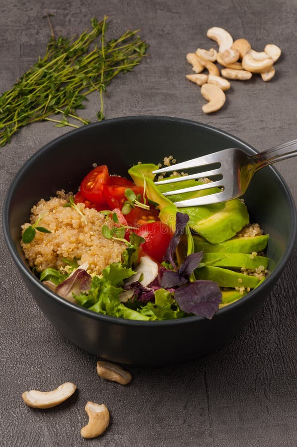 Vegetarian poke with avocado, quinoa and tomatoes royalty free stock image