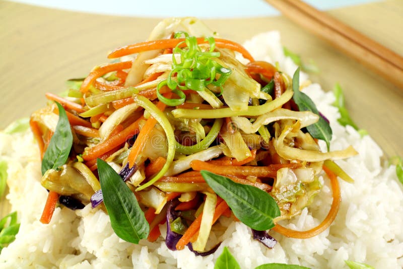 Delicious vegetarian asian stir fry on boiled white rice with thai basil and vietnamese mint. Mint vietnamese stock images, royalty-free photos and pictures