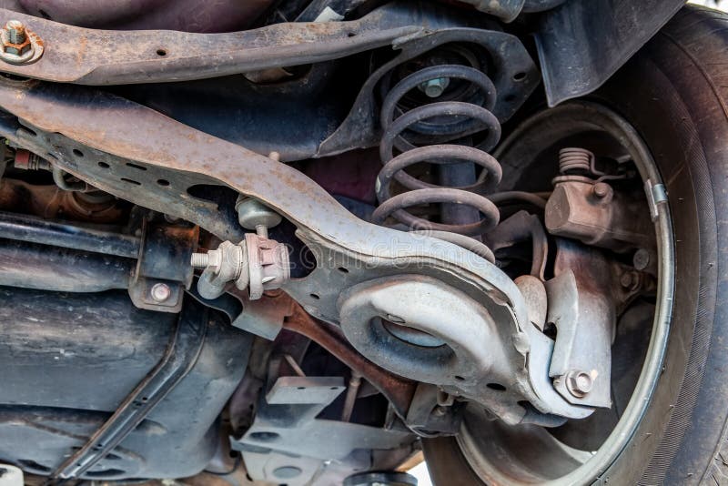 Extreme closeup of vehicle control arm, bushings and joints in a repair shop during inspection. Extreme closeup of vehicle control arm, bushings and joints in a repair shop during inspection