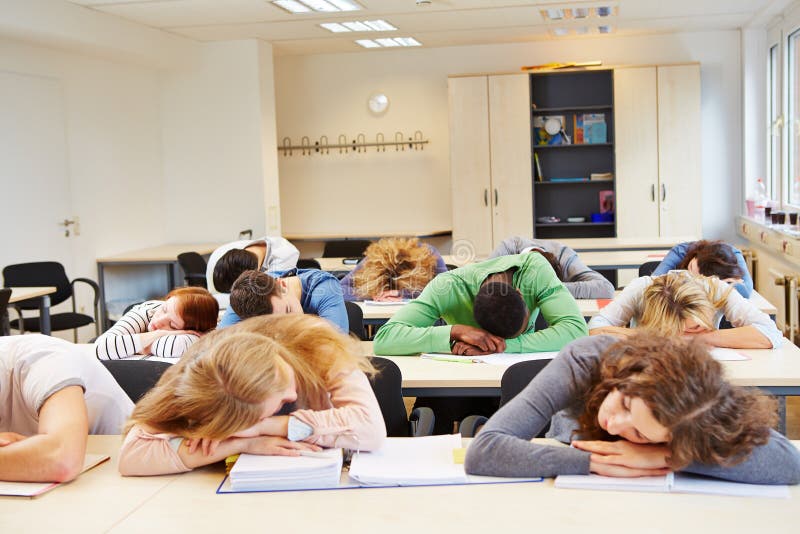 Many tired students sleeping in classroom with their heads on the table. Many tired students sleeping in classroom with their heads on the table