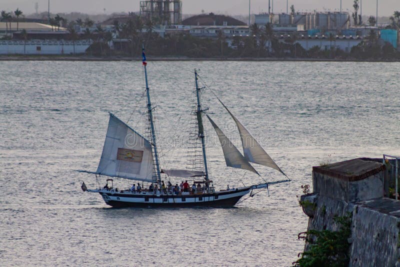 Sailboat cruising through Old San Juan natural bay. In the past, the natural geography of the bay served as an easily defensible port that the Spaniards used to defend the mainland and harbor from outside attacks. Sailboat cruising through Old San Juan natural bay. In the past, the natural geography of the bay served as an easily defensible port that the Spaniards used to defend the mainland and harbor from outside attacks.