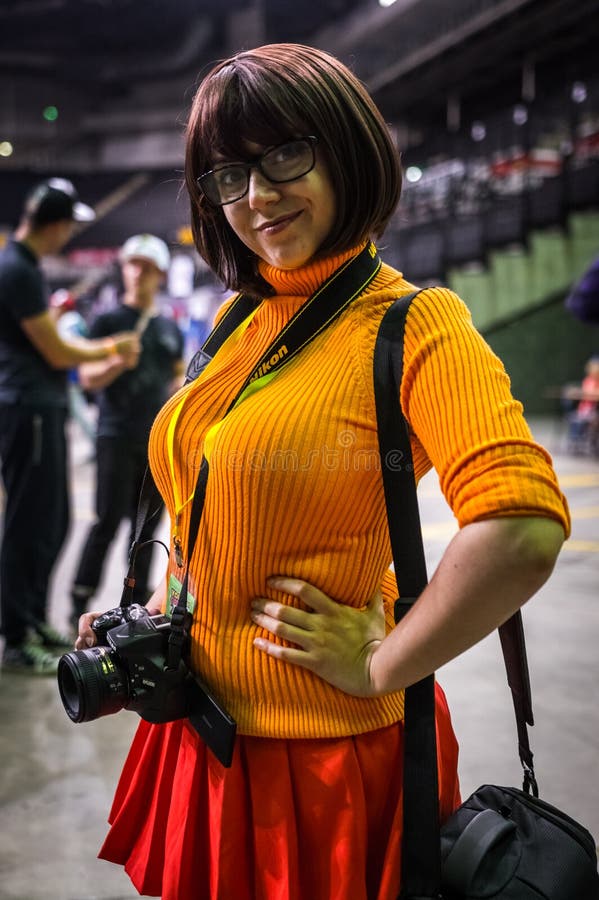 Sheffield, UK - June 12, 2016: Female cosplayer dressed as `Velma` from `Scooby Doo` at the Yorkshire Cosplay Convention at Sheffield Arena. Sheffield, UK - June 12, 2016: Female cosplayer dressed as `Velma` from `Scooby Doo` at the Yorkshire Cosplay Convention at Sheffield Arena