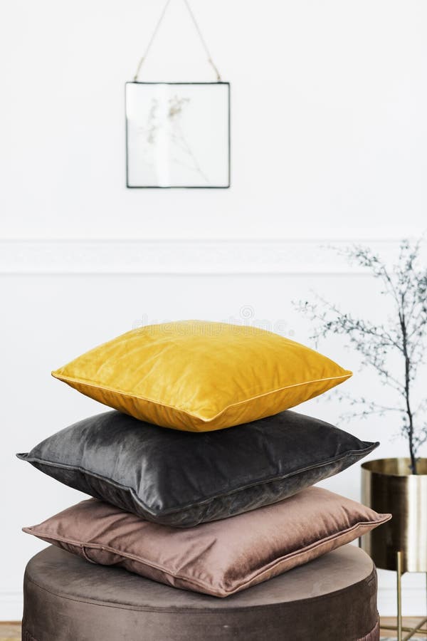 Velur pillows collection on the elegant pouf. stock image