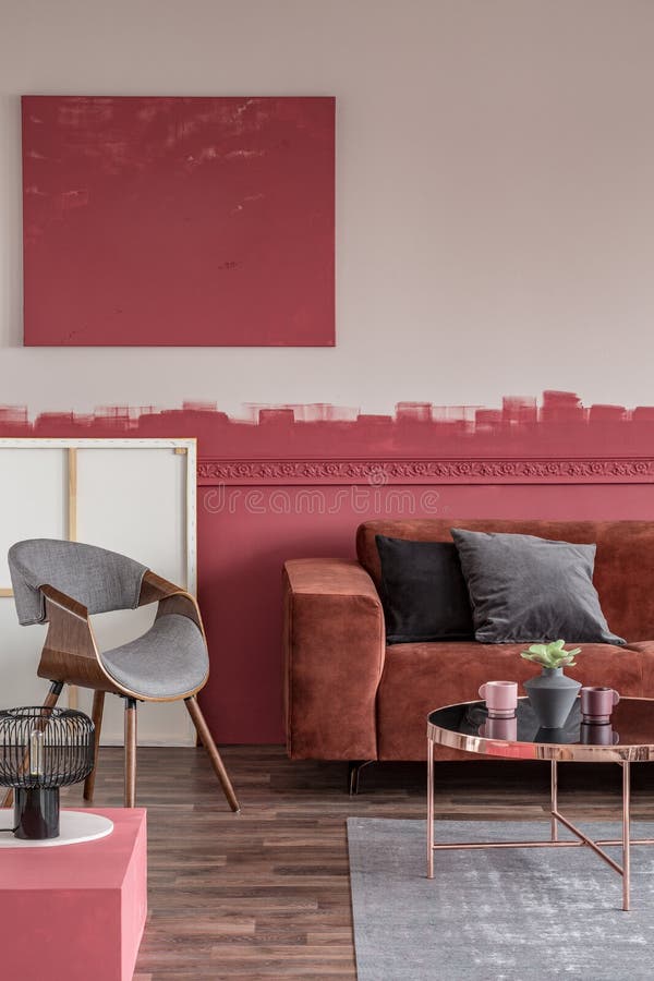 Velvet grey and black pillows on comfortable brown couch in elegant living room with white and red wall stock photo Velvet grey and black pillows on comfortable brown couch in elegant living room with white and red wall stock photo