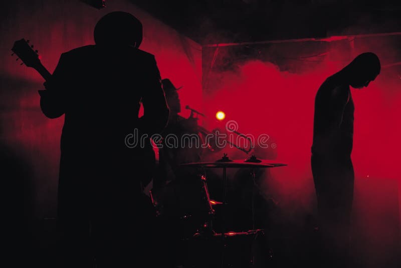 A jazz band shot in silhouette while performing in a club. A jazz band shot in silhouette while performing in a club