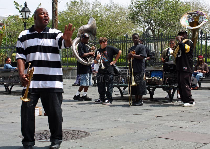 NEW ORLEANS, LOUISIANA - April 13: A jazz band plays in Jackson Square April 13, 2009 in New Orleans, Louisiana after recovery from hurricane Katrina just before the Jazz and Heritage Festival. NEW ORLEANS, LOUISIANA - April 13: A jazz band plays in Jackson Square April 13, 2009 in New Orleans, Louisiana after recovery from hurricane Katrina just before the Jazz and Heritage Festival.