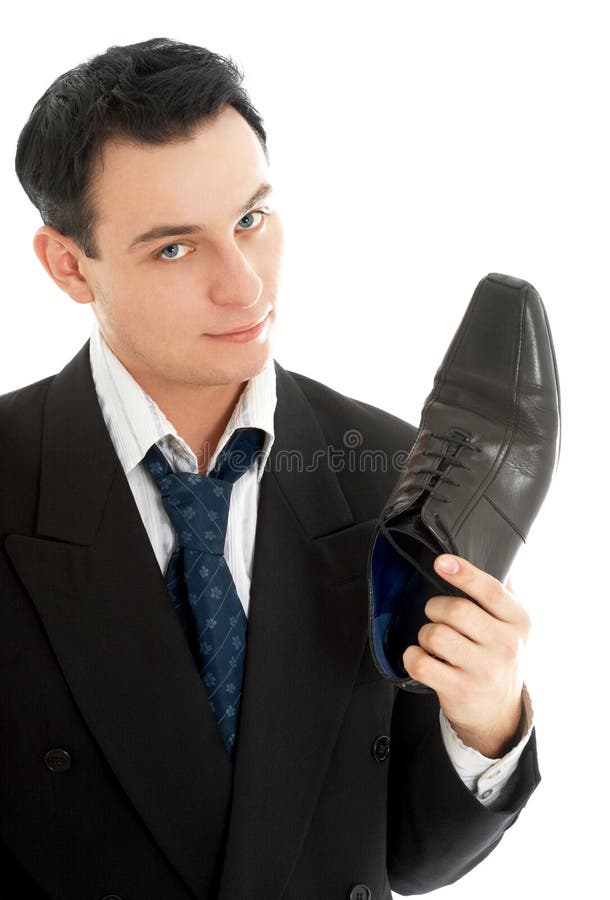 Picture of salesman with black leather boot over white. Picture of salesman with black leather boot over white