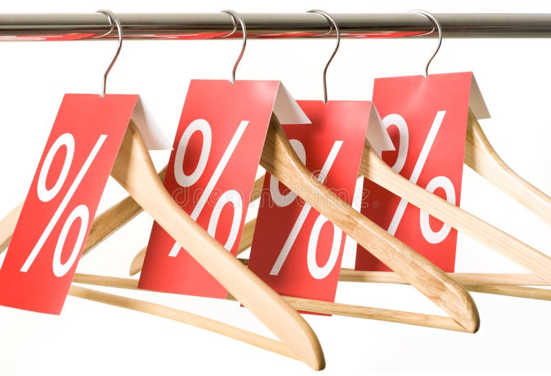 Photo of hangers with red labels showing holiday discount and sale. Photo of hangers with red labels showing holiday discount and sale