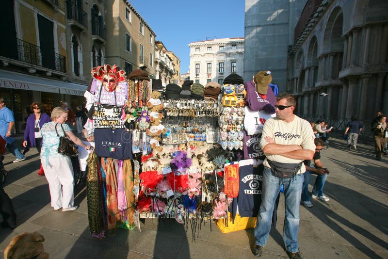 VENICE - OCTOBER 28: Street vendor selling tourist souvenirs on October 28, 2009 in Venice. Most vendors in Venice aren't of Italian origin. VENICE - OCTOBER 28: Street vendor selling tourist souvenirs on October 28, 2009 in Venice. Most vendors in Venice aren't of Italian origin.