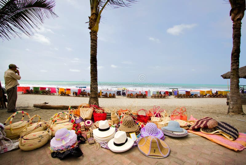 PEDERNALES, ECUADOR - DECEMBER 31, 2009: Street vendor selling straw hats and handbags, Pedernales beach, popular vacation spot in Ecuador. PEDERNALES, ECUADOR - DECEMBER 31, 2009: Street vendor selling straw hats and handbags, Pedernales beach, popular vacation spot in Ecuador.