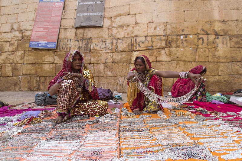 Jaisalmer, India-November 26, 2015:Unidentified street vendor selling a silver necklace in Jaisalmer Fort. The fort also known as Golden Fort of Jaisalmer. Jaisalmer, India-November 26, 2015:Unidentified street vendor selling a silver necklace in Jaisalmer Fort. The fort also known as Golden Fort of Jaisalmer.
