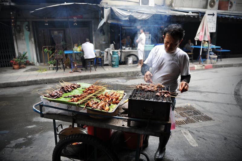 A street vendor cooks at a roadside restaurant on January 27, 2012 in Bangkok, Thailand. According to government statistics there are over 16,000 registered street vendors in Bangkok. A street vendor cooks at a roadside restaurant on January 27, 2012 in Bangkok, Thailand. According to government statistics there are over 16,000 registered street vendors in Bangkok.