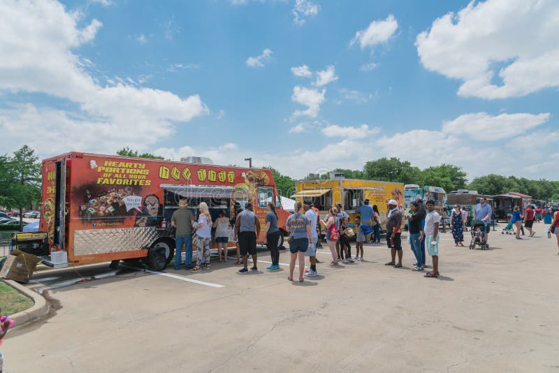 IRVING, TX, USA-MAY 19, 2018:Food truck vendor customer buy and taste variety of food at The Taste of Irving 2018 event. An outdoor festival featuring family-friendly activities, live music and food. IRVING, TX, USA-MAY 19, 2018:Food truck vendor customer buy and taste variety of food at The Taste of Irving 2018 event. An outdoor festival featuring family-friendly activities, live music and food