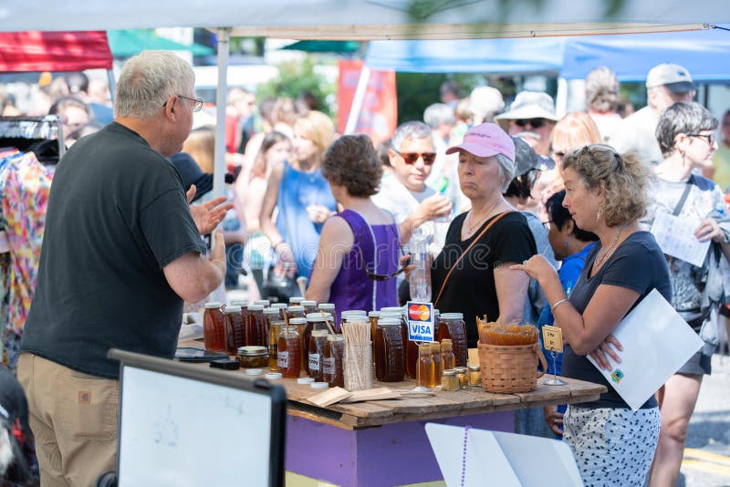 Portland, OR / USA - August 18 2018: Honey vendor at the outdoor event. Portland, OR / USA - August 18 2018: Honey vendor at the outdoor event.