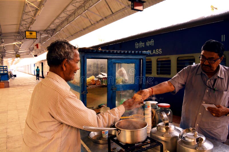 A tea vendor taking money for his service in a rail station in India. Photo taken on 27th April 2016. A tea vendor taking money for his service in a rail station in India. Photo taken on 27th April 2016