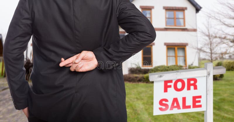 venditore della proprietà con le sue dita attraversate immagini stock venditore della proprietà con le sue dita attraversate immagini stock