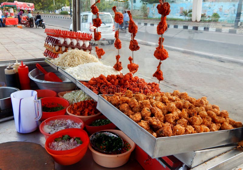 Indian street food vendor ready with ingredients to cook fast food on cart on a busy road on August 19,2016 in Hyderabad,India. Indian street food vendor ready with ingredients to cook fast food on cart on a busy road on August 19,2016 in Hyderabad,India