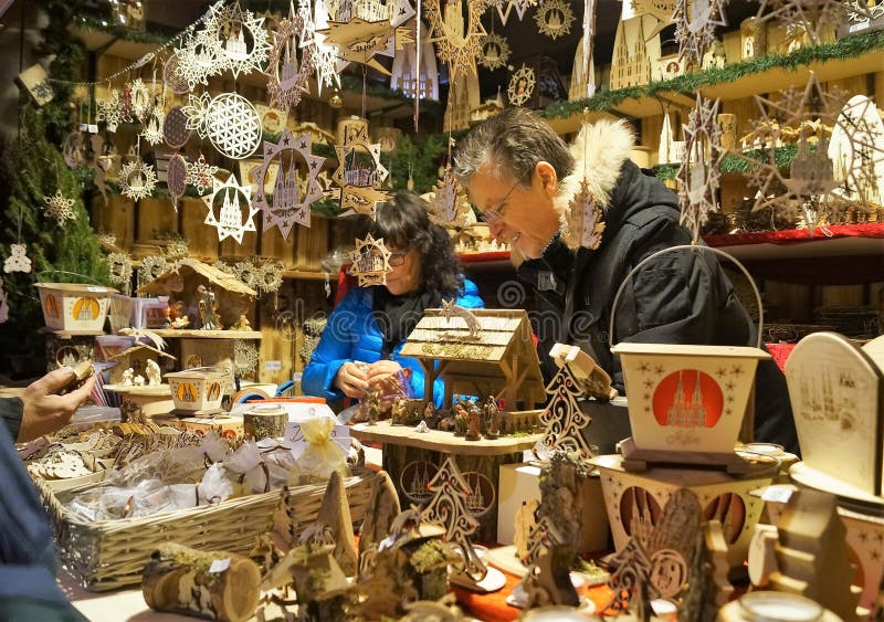 Cologne, Germany â€“ December 16, 2017: A vendor sells handmade wood crafts at the annual Cologne Cathedral Christmas market. Cologne, Germany â€“ December 16, 2017: A vendor sells handmade wood crafts at the annual Cologne Cathedral Christmas market.