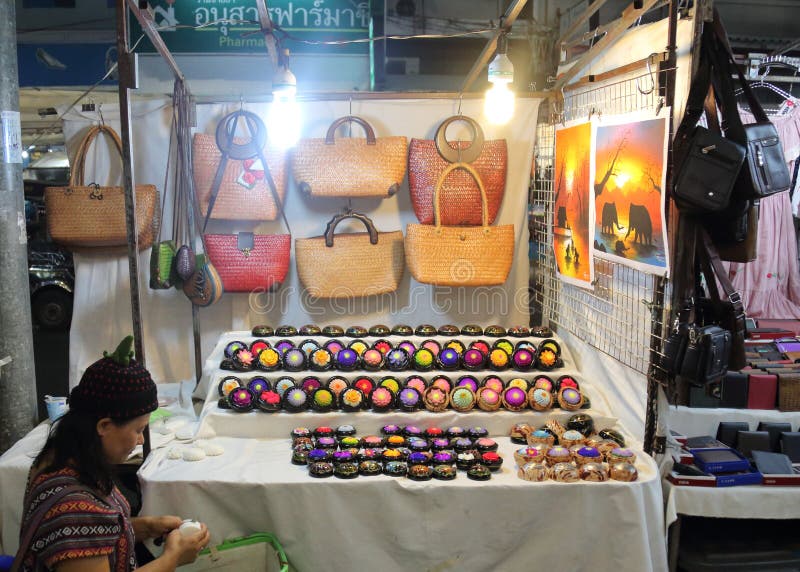 Vendor in the Chiang Mai Night Bazaar. Female vendor in the Chiang Mai Night Bazaar carves soap to make her wares royalty free stock photos Vendor in the Chiang Mai Night Bazaar. Female vendor in the Chiang Mai Night Bazaar carves soap to make her wares royalty free stock photos