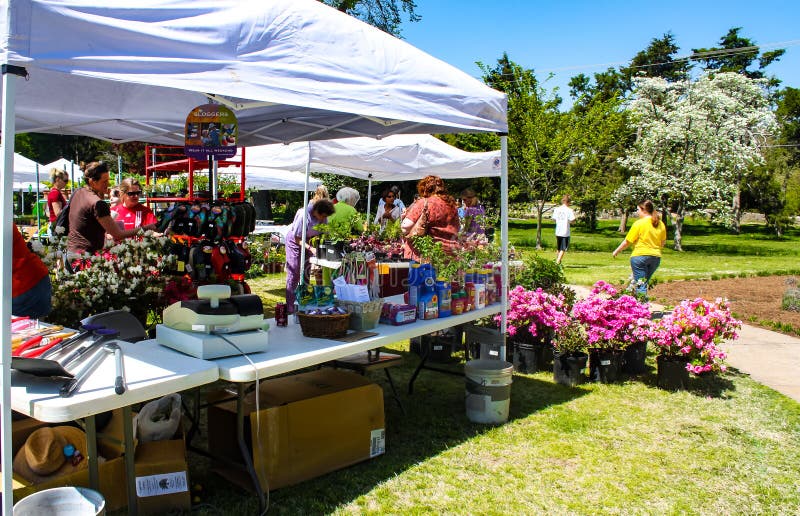 Vendor tent with flowers for sale and customers at Spring Garden Show at Tulsa Garden Center - Tulsa USA circa April 2010