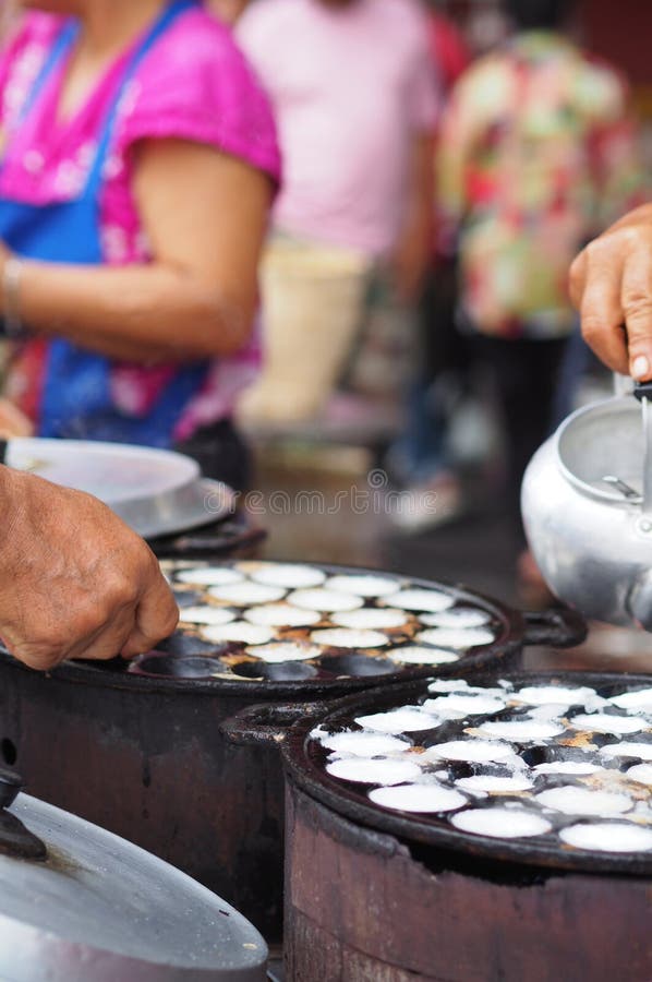 Vendors Prepare Traditional Snacks To Sell at a Market. Stock Image