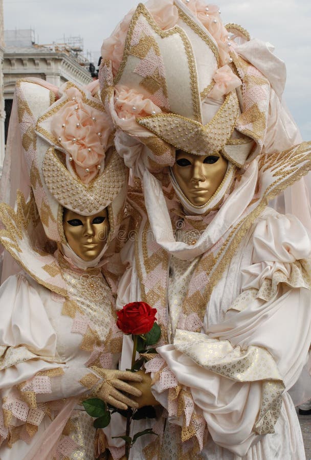 Two Venice carnival goers pose for photographs. Two Venice carnival goers pose for photographs