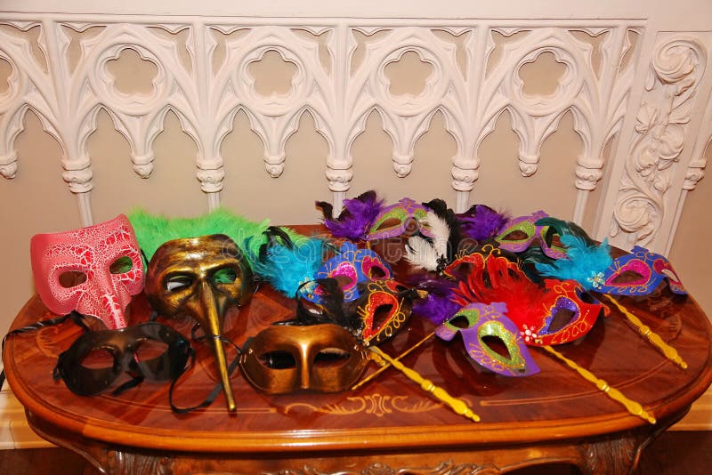 Venetian carnival masks. Party masks on a table. stock photo Venetian carnival masks. Party masks on a table. stock photo