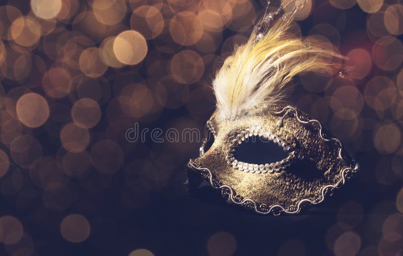 Golden venetian mask over black background. Golden venetian mask over black background