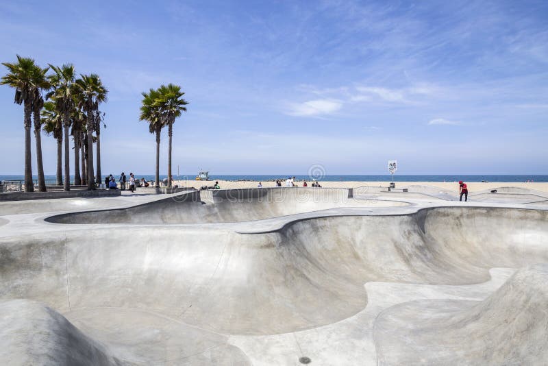 Los Angeles, California, USA - June 20, 2014: Concrete ramps and palm trees at the popular Venice beach skateboard park in Los Angeles, California. Los Angeles, California, USA - June 20, 2014: Concrete ramps and palm trees at the popular Venice beach skateboard park in Los Angeles, California.