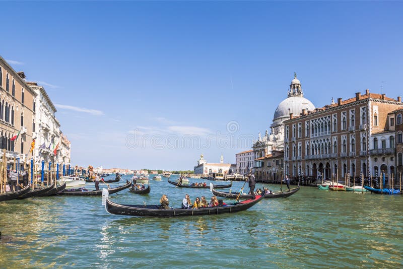 Venice, the Grand canal, the Cathedral of Santa Maria della Salute and gondolas with tourists