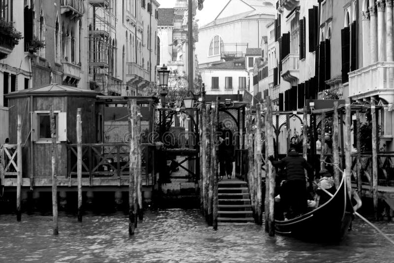 Venice, Italy, December 28, 2018 evocative black and white image of a mooring for gondolas stock photography