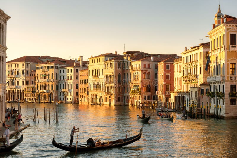 Gondolas floats on the Grand Canal in Venice at sunset