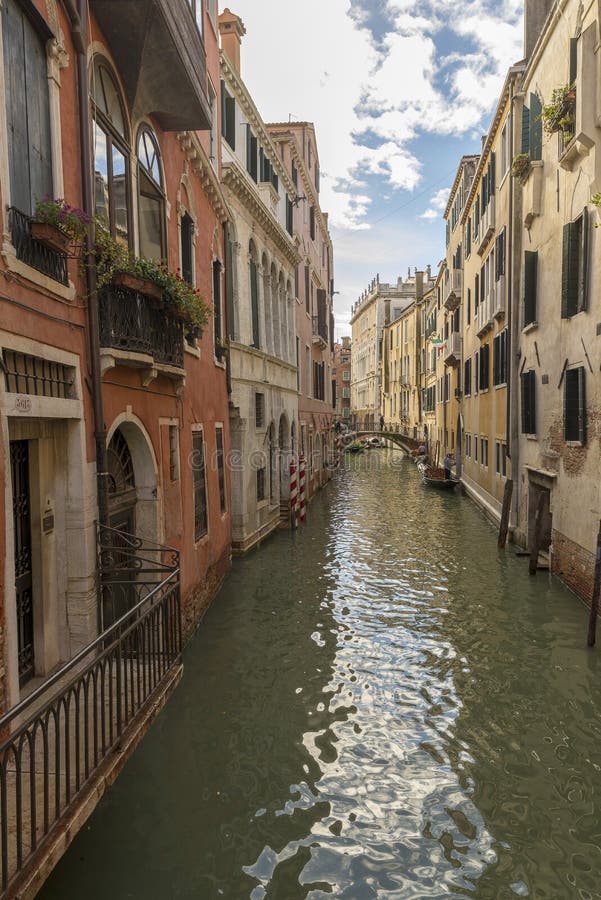 Traditional narrow canal with gondolas in Venice, Italy stock photo Traditional narrow canal with gondolas in Venice, Italy stock photo