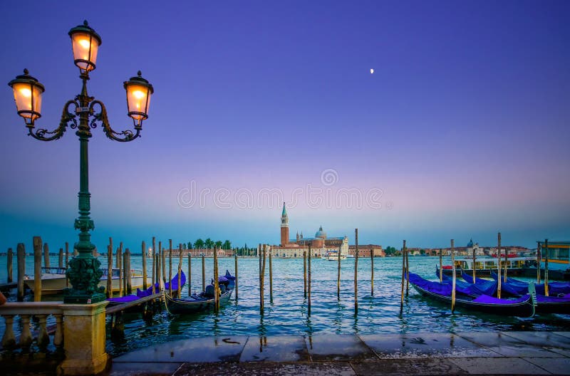 Venice, street lamp and gondolas or gondole on sunset and church on background. Italy stock photography Venice, street lamp and gondolas or gondole on sunset and church on background. Italy stock photography