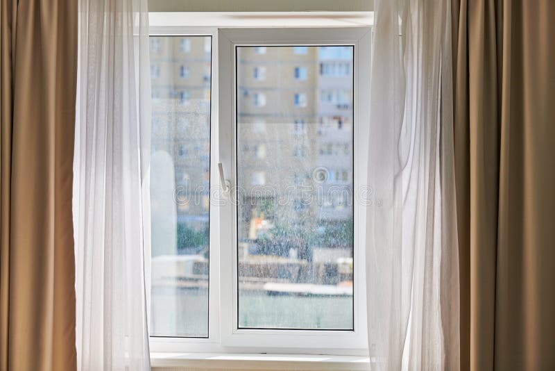 Dirty window in apartment. Unwashed dusty glass, city street view background. Unclean double glazed window. Dirty window in apartment. Unwashed dusty glass, city street view background. Unclean double glazed window