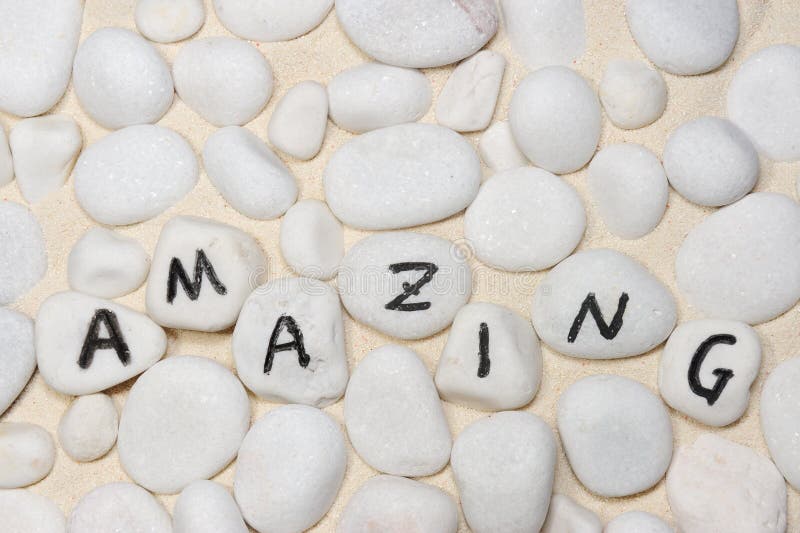 Amazing word on group of pebbles on the sand. Amazing word on group of pebbles on the sand