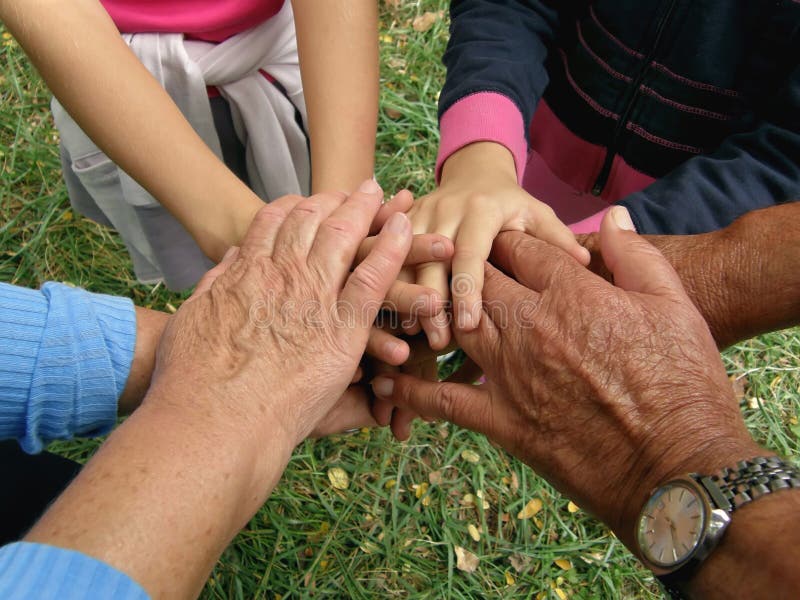Different generations of a family (grandparents and grandchildren) take with clasped hands. Horizontal color photo. Different generations of a family (grandparents and grandchildren) take with clasped hands. Horizontal color photo.