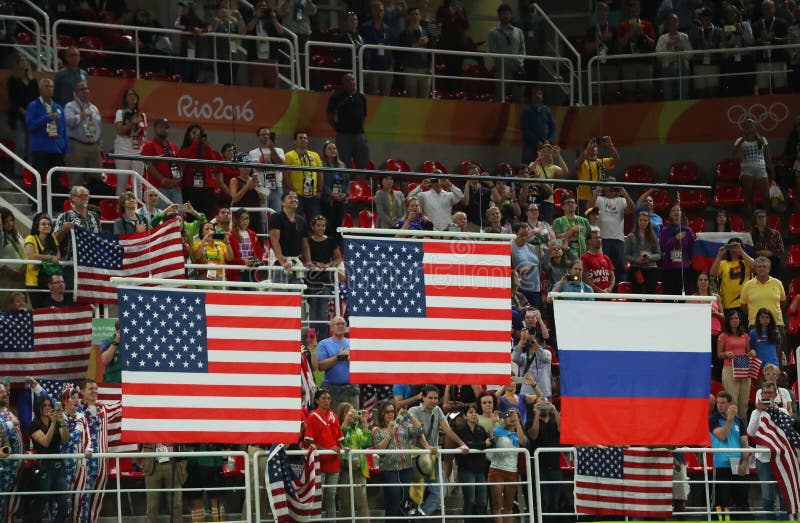 RIO DE JANEIRO, BRAZIL -AUGUST 11, 2016: Unites States and Russian Federation flags raised during women`s all-around gymnastics medal ceremony at Rio 2016 Olympic Games. RIO DE JANEIRO, BRAZIL -AUGUST 11, 2016: Unites States and Russian Federation flags raised during women`s all-around gymnastics medal ceremony at Rio 2016 Olympic Games