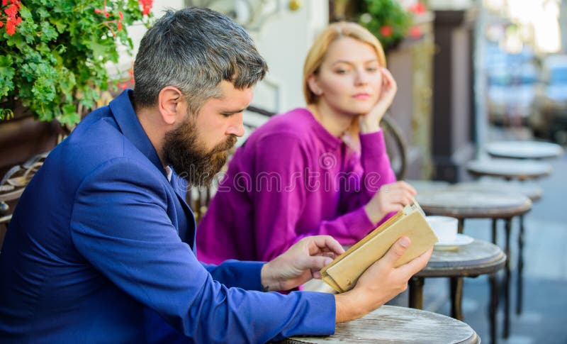 Vergaderingsmensen met gelijklopende interesses De man en de vrouw zitten koffieterras Het meisje interesseerde wat hij lezing li