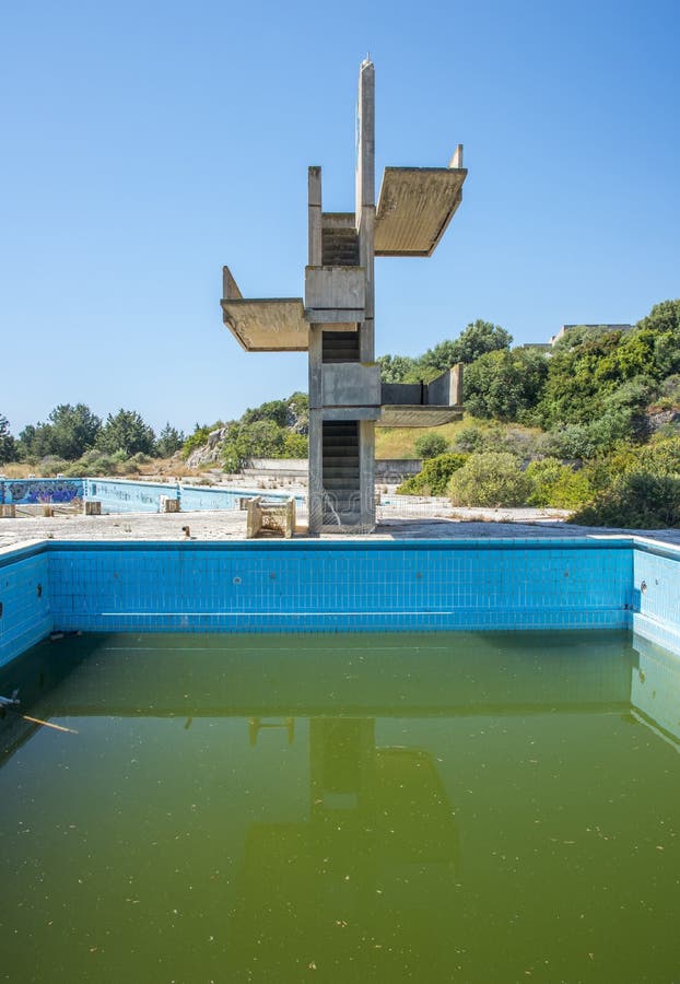 An abandoned lido complex on the island of rhodes in Greece where the swimming pools have filled with rain water and tuend green with algae. An abandoned lido complex on the island of rhodes in Greece where the swimming pools have filled with rain water and tuend green with algae