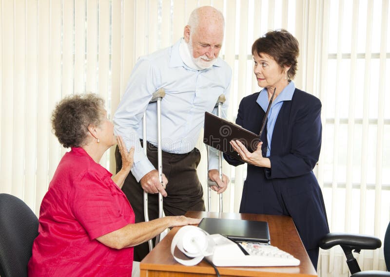 Injured man and his wife meet with a personal injury lawyer. Injured man and his wife meet with a personal injury lawyer.