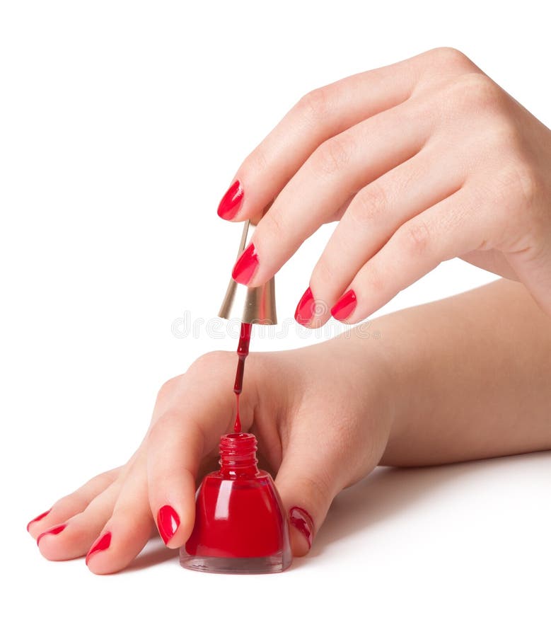 Manicurist applying red nail polish on female fingers. Manicurist applying red nail polish on female fingers