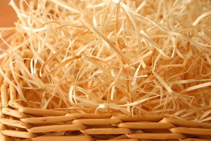 Wood wool, otherwise known as Excelsior, is finely shredded wood that looks like straw, in a wicker basket. Wood wool, otherwise known as Excelsior, is finely shredded wood that looks like straw, in a wicker basket.