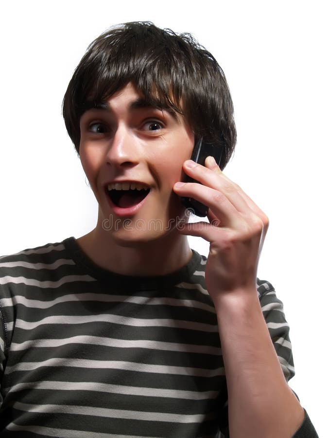 A portrait about a trendy handsome guy who is chatting with somebody by mobile phone and he is surprised. He is wearing a striped t-shirt. A portrait about a trendy handsome guy who is chatting with somebody by mobile phone and he is surprised. He is wearing a striped t-shirt.