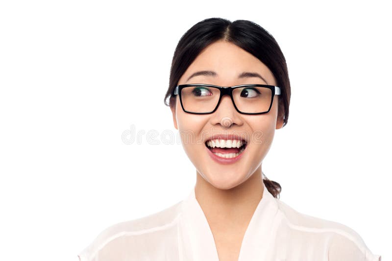 Pretty asian girl looking away in excitement, wearing spectacles. Pretty asian girl looking away in excitement, wearing spectacles