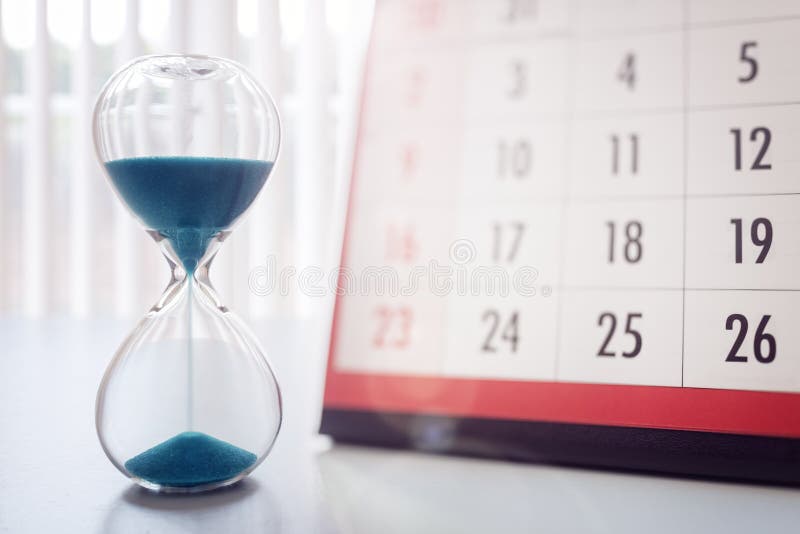 Hour glass and calendar concept for time slipping away for important appointment date, schedule and deadline. Hour glass and calendar concept for time slipping away for important appointment date, schedule and deadline