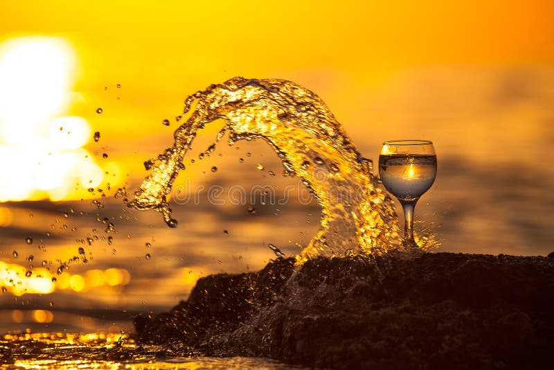 Verre de la vigne blanche avec des réflexions du soleil et de mer sur le backg photos libres de droits Verre de la vigne blanche avec des réflexions du soleil et de mer sur le backg photos libres de droits