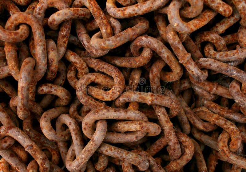 Rusted chains tangled as a background with a group of old textured [ iron metal links as an icon of a vintage prison chain or obsolete industry symbol of an ancient economy in decline. Rusted chains tangled as a background with a group of old textured [ iron metal links as an icon of a vintage prison chain or obsolete industry symbol of an ancient economy in decline.