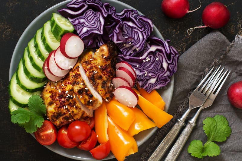 Verse groenten met gebakken kippenborst dicht omhoog op rustieke achtergrond, hoogste mening Rode kool, radijs, paprika, koriande stock foto Verse groenten met gebakken kippenborst dicht omhoog op rustieke achtergrond, hoogste mening Rode kool, radijs, paprika, koriande stock foto