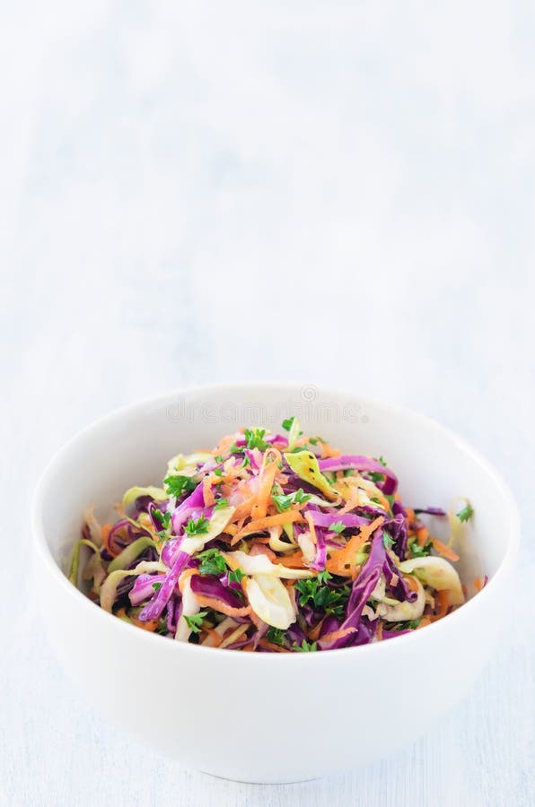 Coleslaw a healthy vibrant colourful salad made with shredded raw cabbage, carrots and onions. Coleslaw a healthy vibrant colourful salad made with shredded raw cabbage, carrots and onions